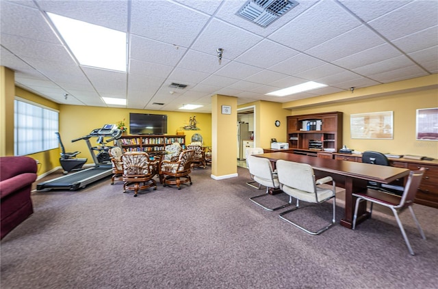 interior space with a drop ceiling, visible vents, and baseboards