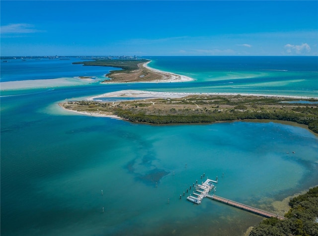 drone / aerial view featuring a water view and a view of the beach