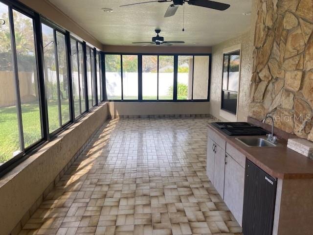 unfurnished sunroom featuring a sink