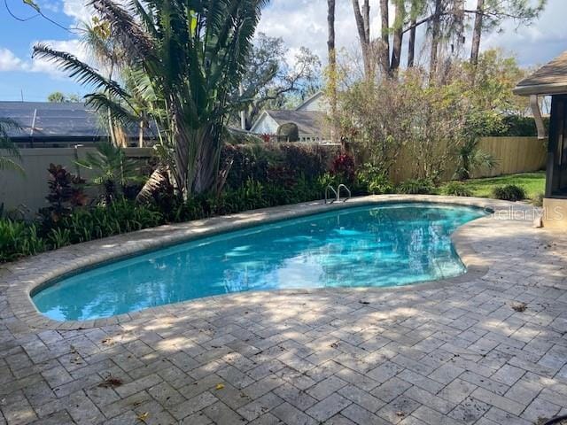 view of swimming pool with a fenced in pool, a patio area, and a fenced backyard