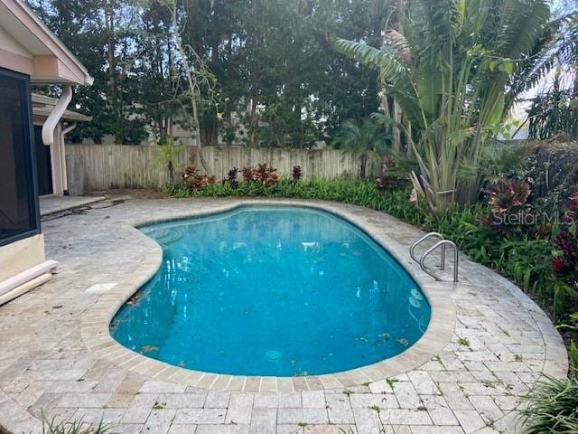 view of pool featuring fence, a fenced in pool, and a patio