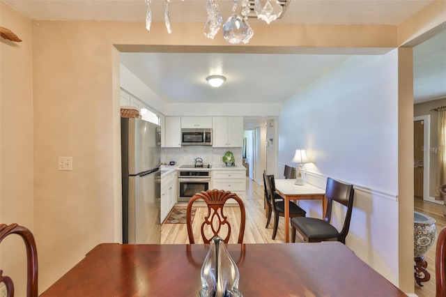 dining space with light wood-type flooring