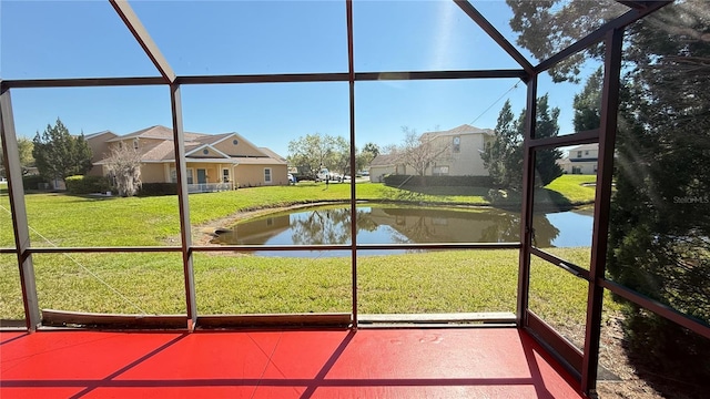 unfurnished sunroom featuring a water view