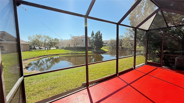 unfurnished sunroom with a water view