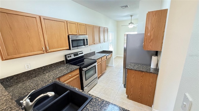 kitchen with visible vents, ceiling fan, appliances with stainless steel finishes, a sink, and light tile patterned floors