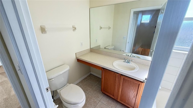bathroom featuring toilet, vanity, and tile patterned floors