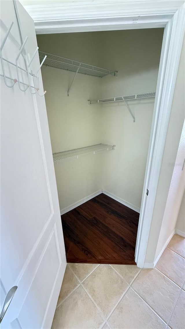 spacious closet with tile patterned floors