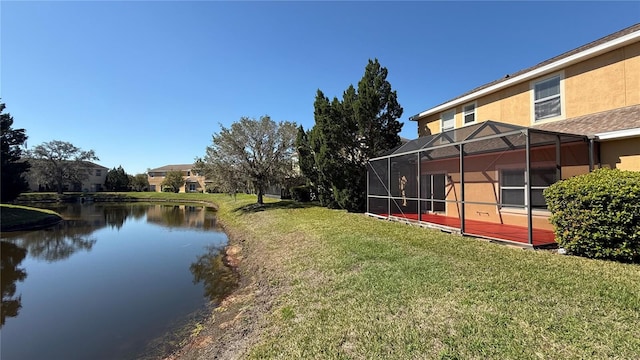 view of yard with a water view and a lanai