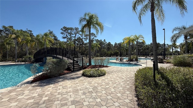 community pool with a patio area