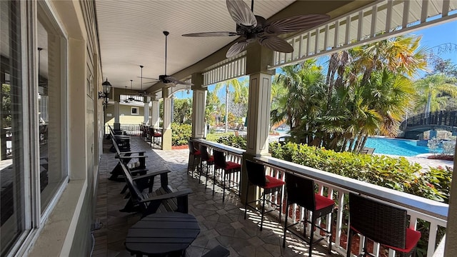 view of patio featuring outdoor dry bar and ceiling fan
