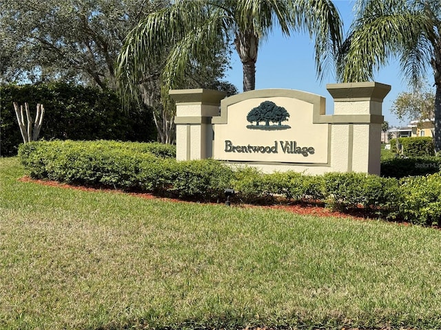 community sign featuring a lawn