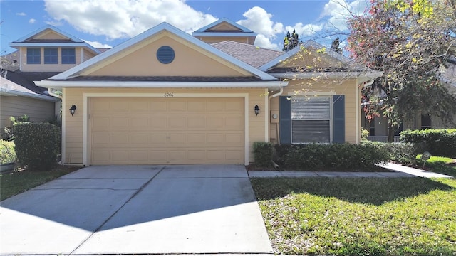 view of front of house with a garage and concrete driveway