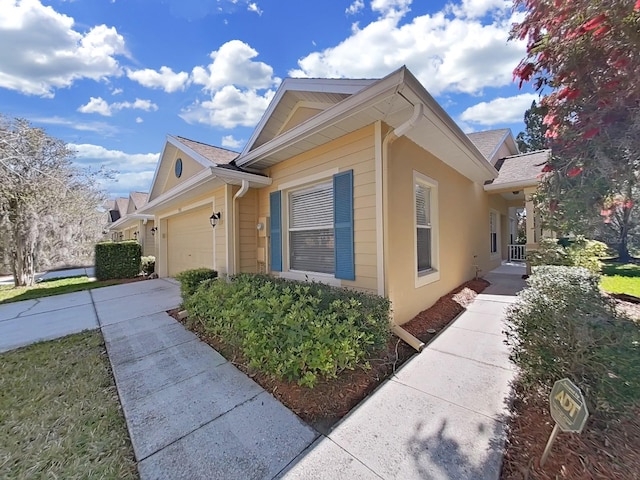 view of property exterior with driveway and a garage