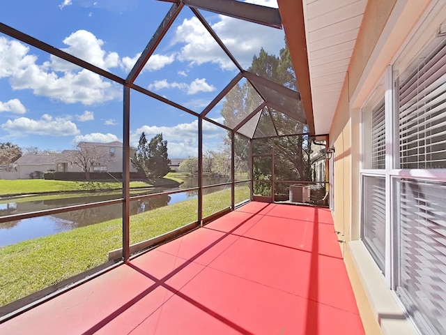 unfurnished sunroom featuring a water view
