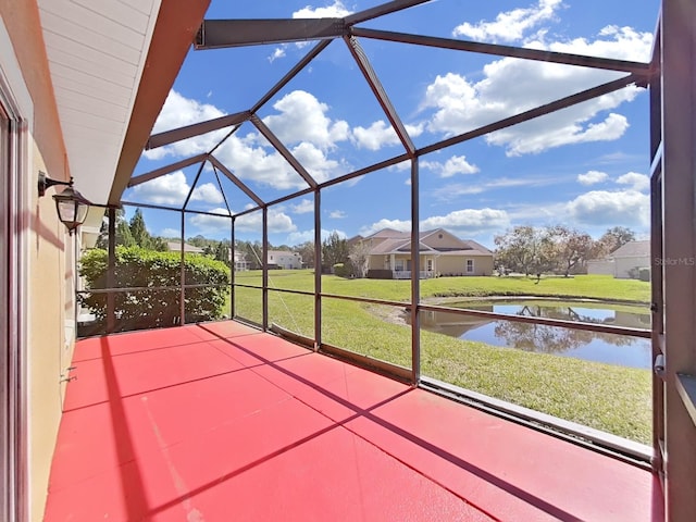 unfurnished sunroom featuring a water view