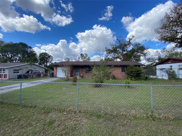 view of front of house with an attached garage, driveway, a front lawn, and brick siding