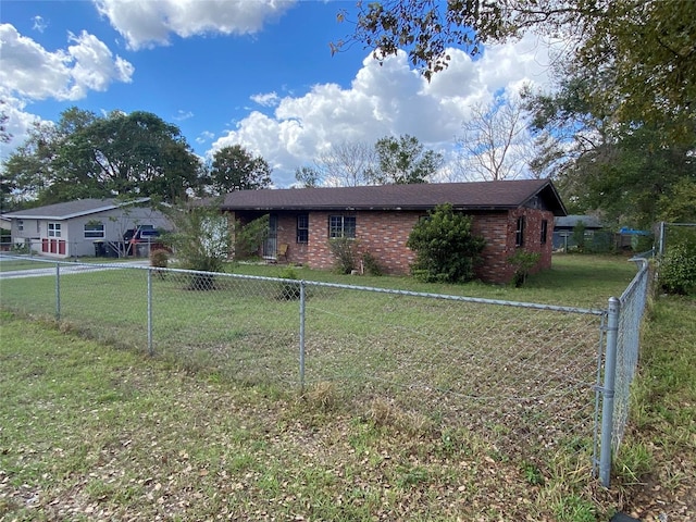 view of front of house featuring fence private yard, a front yard, and brick siding