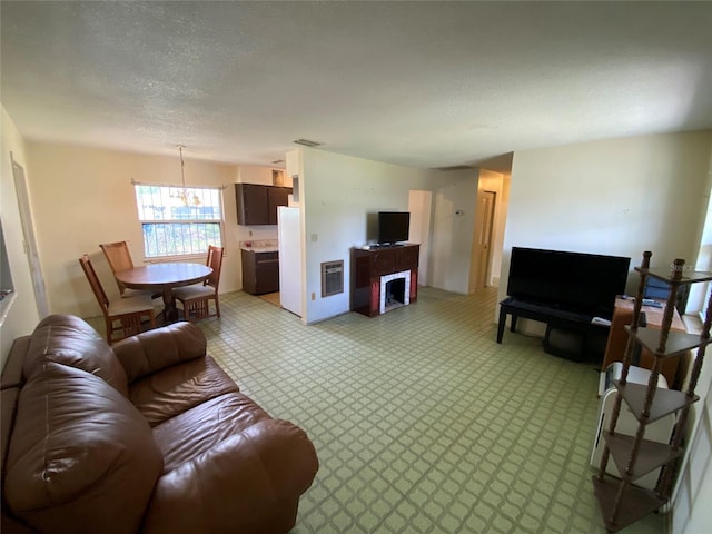 living room with visible vents and a textured ceiling