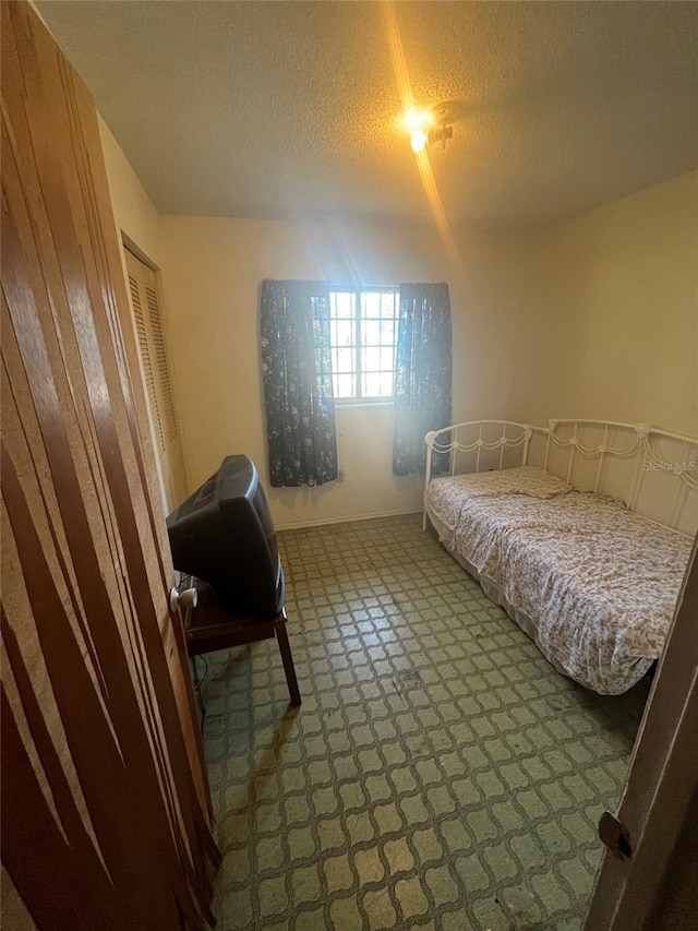 carpeted bedroom with a textured ceiling