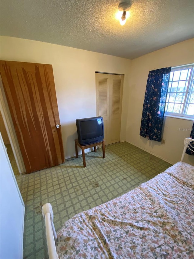 bedroom with a closet and a textured ceiling