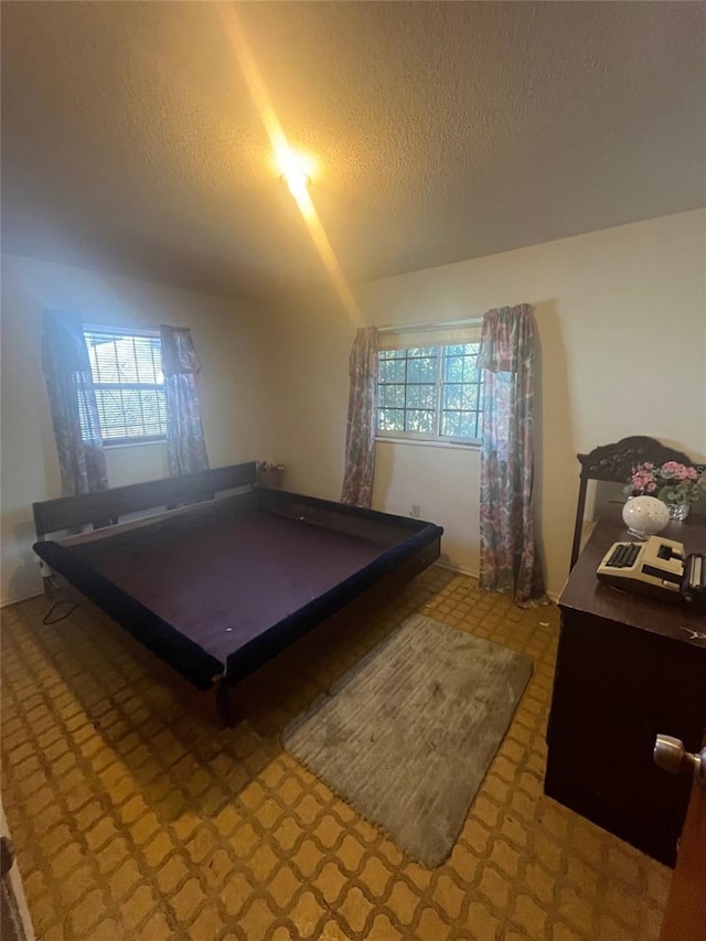 recreation room featuring a textured ceiling and plenty of natural light