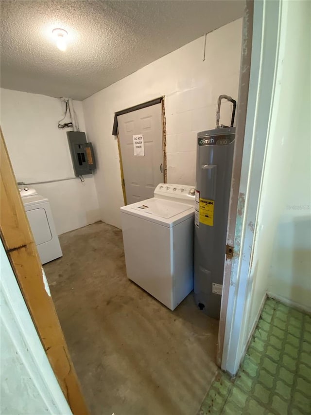 laundry room featuring water heater, laundry area, washer / clothes dryer, and concrete block wall