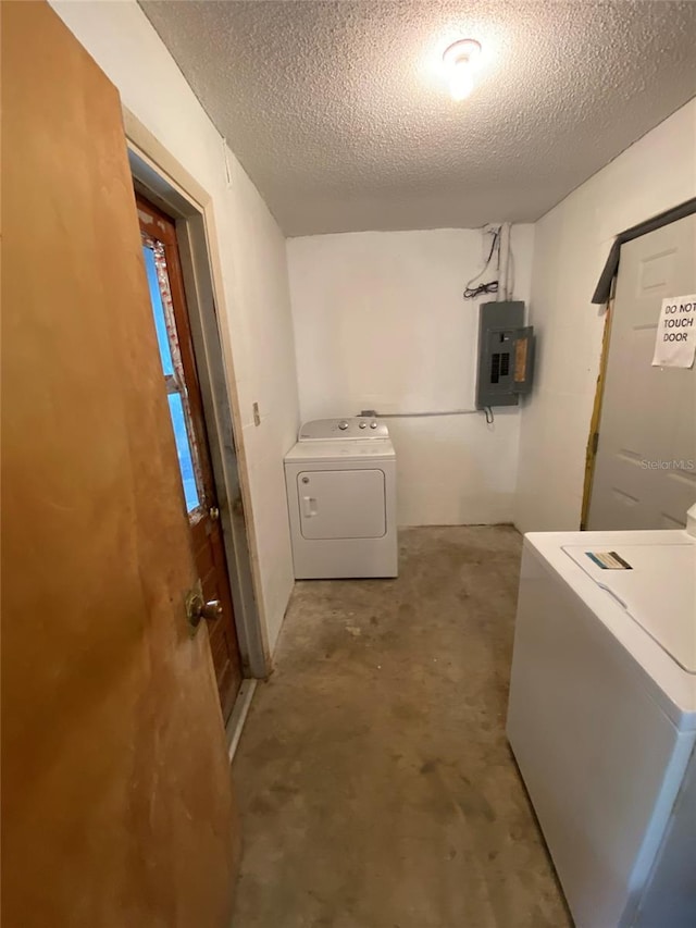 washroom featuring washer / dryer, laundry area, electric panel, and a textured ceiling