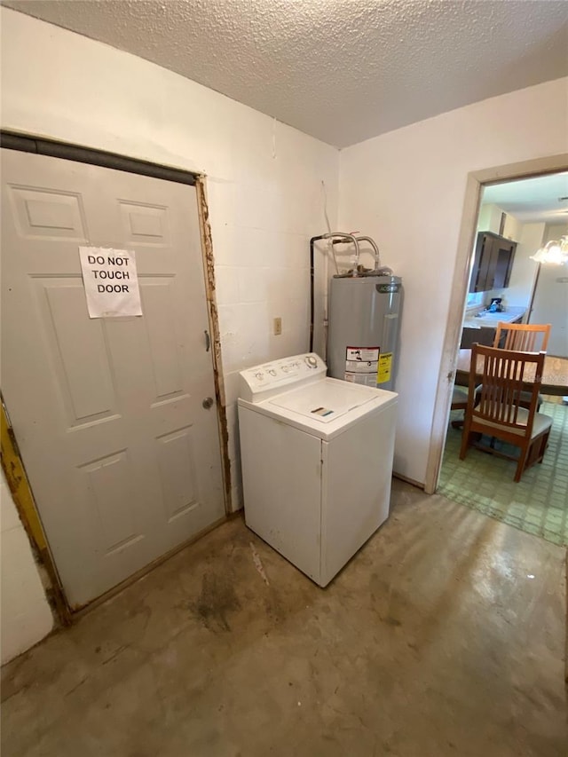 washroom with concrete block wall, water heater, a textured ceiling, washer / dryer, and laundry area