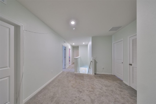 unfurnished room with recessed lighting, visible vents, baseboards, and light colored carpet