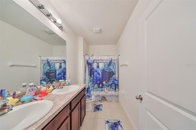 full bath with toilet, tile patterned flooring, a textured ceiling, and a sink