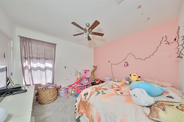 carpeted bedroom featuring a textured ceiling and a ceiling fan