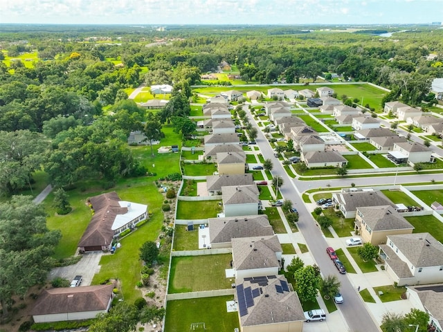 birds eye view of property with a forest view and a residential view