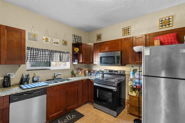 kitchen with a textured ceiling, stainless steel appliances, open shelves, and a sink