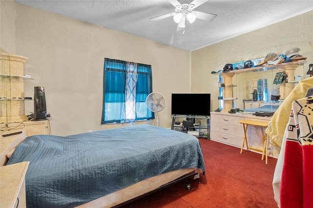 bedroom with a textured ceiling, a textured wall, carpet floors, and a ceiling fan