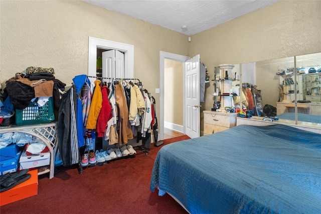 carpeted bedroom with a textured ceiling and a textured wall