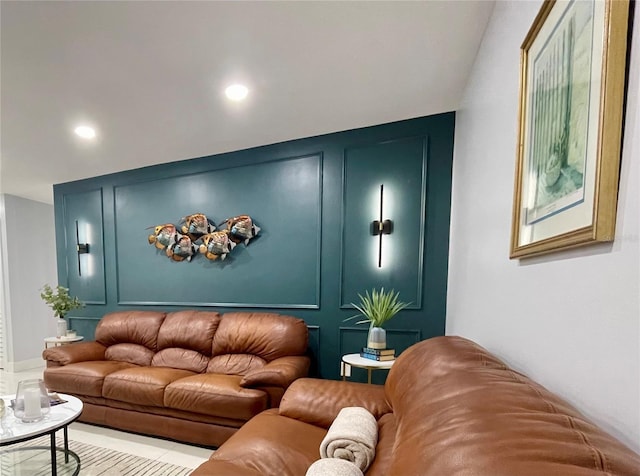 living room featuring recessed lighting and a decorative wall