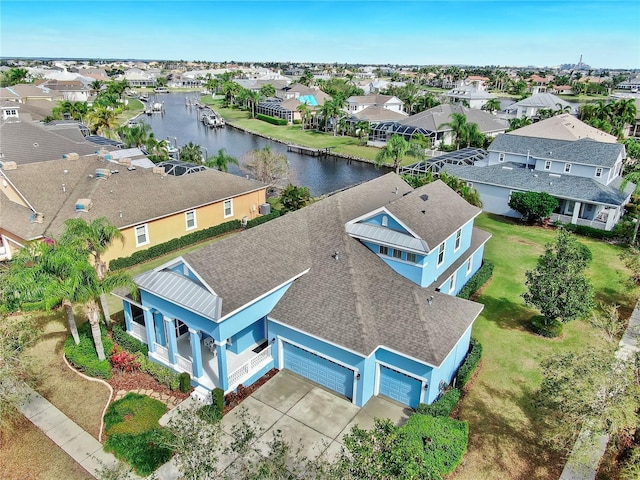 bird's eye view featuring a residential view and a water view