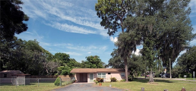 ranch-style home with fence and a front lawn