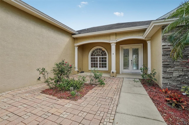 property entrance with french doors and stucco siding