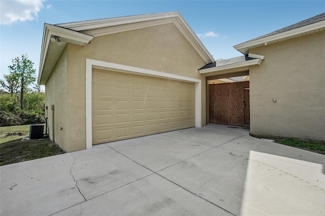 garage featuring concrete driveway