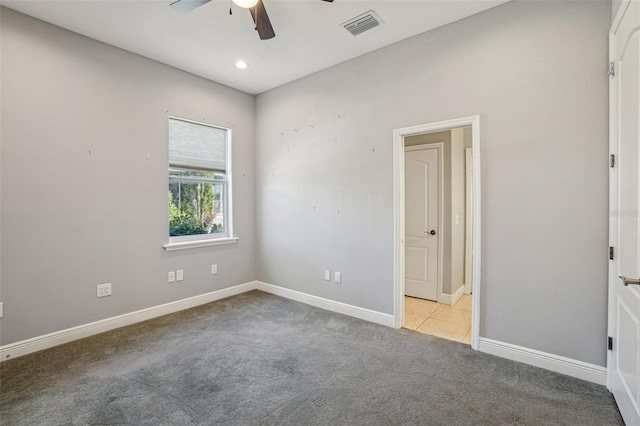 spare room with carpet, recessed lighting, visible vents, a ceiling fan, and baseboards