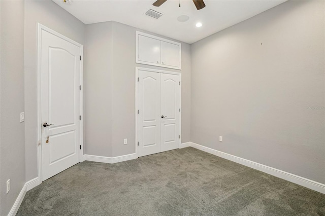 unfurnished bedroom with baseboards, visible vents, ceiling fan, carpet floors, and a closet