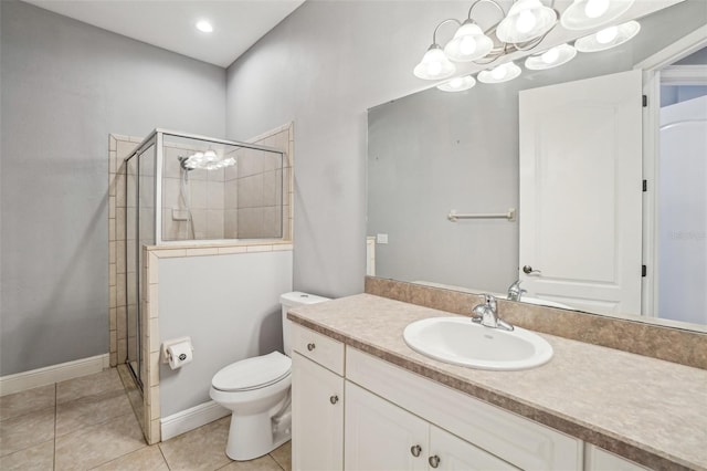 bathroom with tile patterned flooring, toilet, vanity, baseboards, and a shower stall