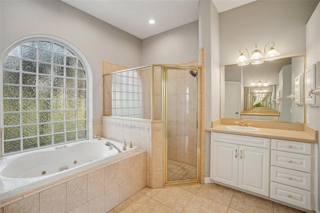 full bathroom with a stall shower, a tub with jets, and a wealth of natural light