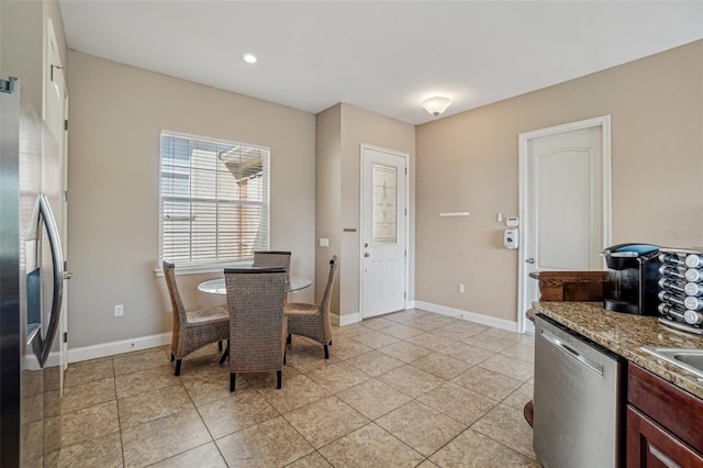 dining area featuring baseboards and light tile patterned flooring