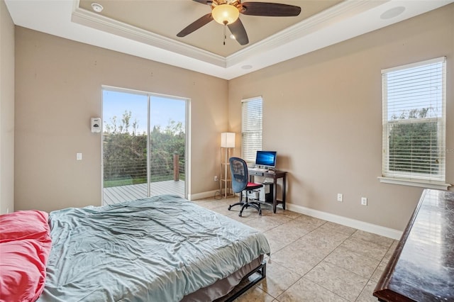 bedroom featuring access to outside, a tray ceiling, multiple windows, and crown molding