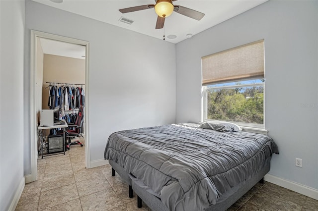 bedroom featuring baseboards, visible vents, a ceiling fan, and light tile patterned flooring