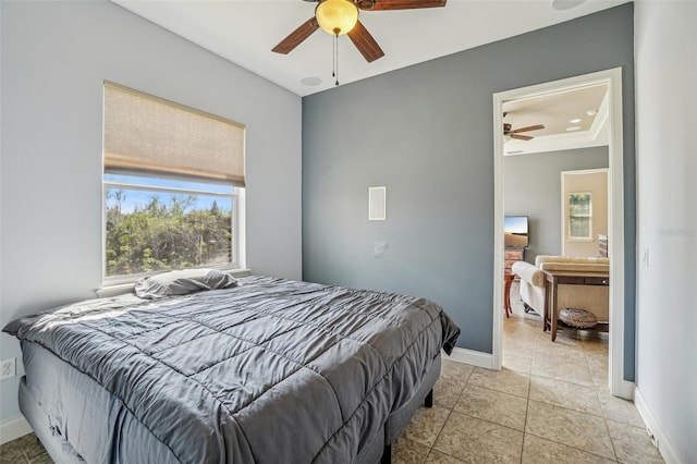 bedroom with baseboards, a ceiling fan, and light tile patterned flooring