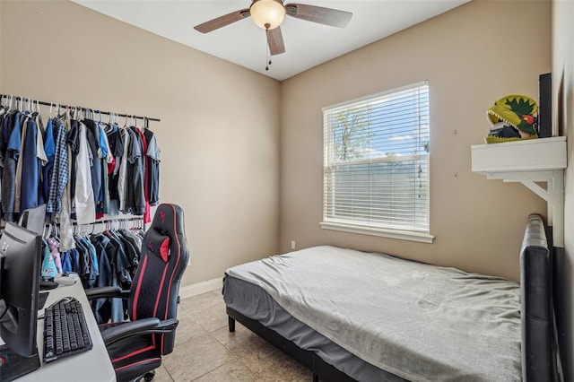 bedroom featuring ceiling fan, tile patterned flooring, and baseboards