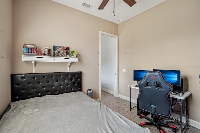 tiled bedroom with visible vents, ceiling fan, and baseboards